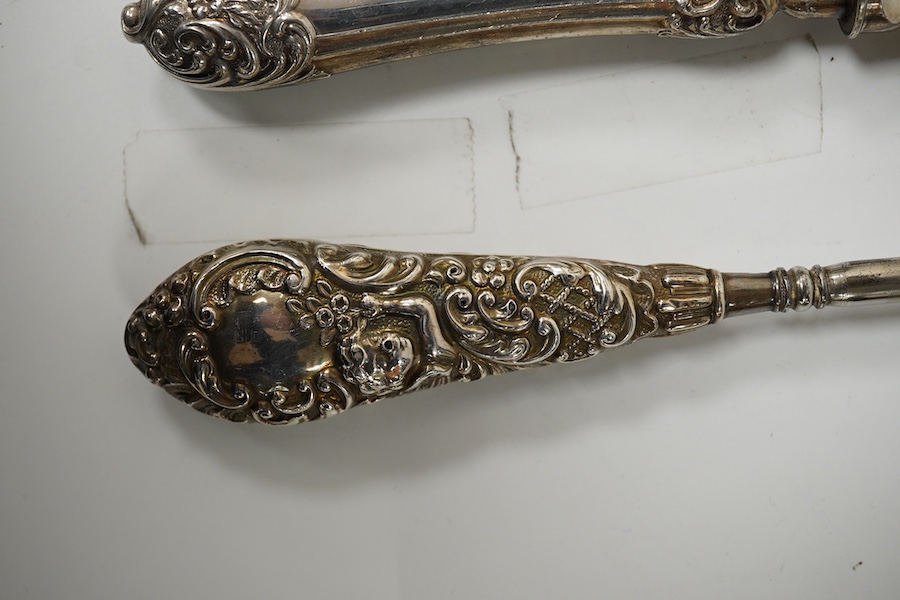 An Edwardian silver cake knife with engraved blade and decorative handle, James Deakin & Sons, Sheffield, 1901, together with a late Victorian silver handled button hook and silver handled shoe horn. Condition - poor to